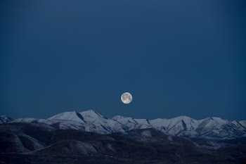 full-moon above snow-capped mountain painting