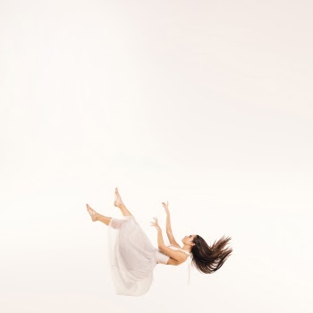 Full shot woman in white dress floating Free Photo