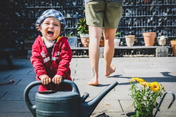 Funny baby Ben helps with gardening and screams for joy.