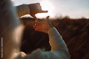 Future planning idea concept, woman making frame round the sun with her hands in sunrise, business concept