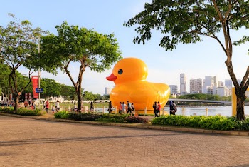 Giant Rubber Ducky on Body of Water at Park With People