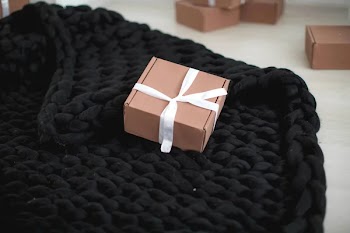 Gift boxes and black knitted plaid