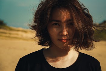 Gilr Wearing a Black Crew-neck Top