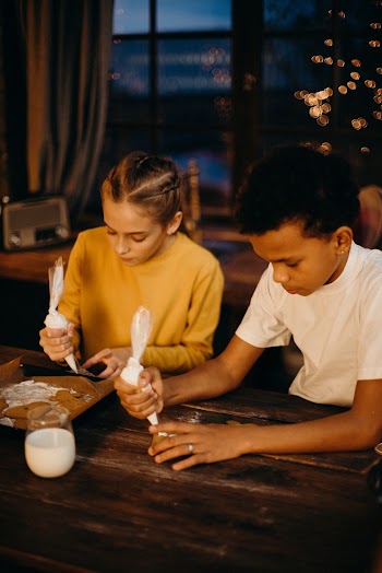 Girl and Boy Putting Whip Cream While Sitting