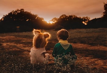 Girl and Boy Sitting on Ground