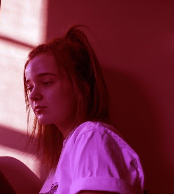 Girl Beside Brown Wall