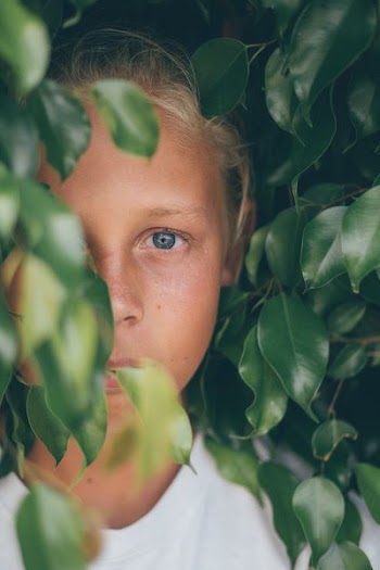 girl beside plant