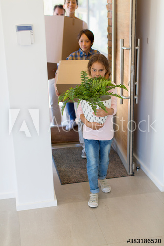 Girl carrying potted plant into new house