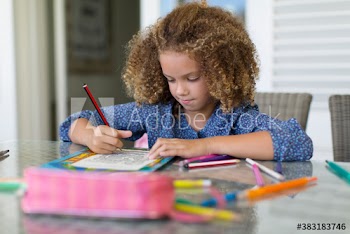 Girl coloring at table