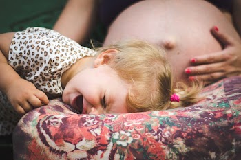 Girl Crying on Woman's Lap