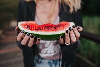 Girl eating watermelon outside 