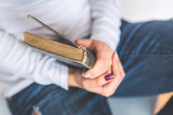 Girl holding an old closed book