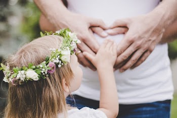 Girl Holding Her Mother's Tummy