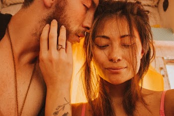 Girl Holding Mans Face Close-up Photography