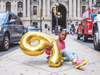 Girl Holding Number Nine Balloon