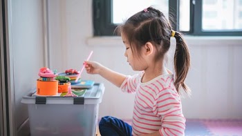 girl holding paint brush