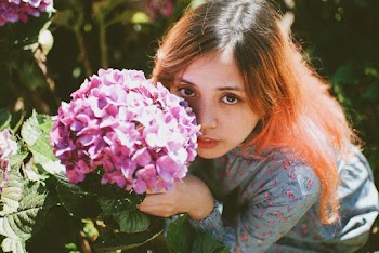 Girl Holding Purple Petaled Flower