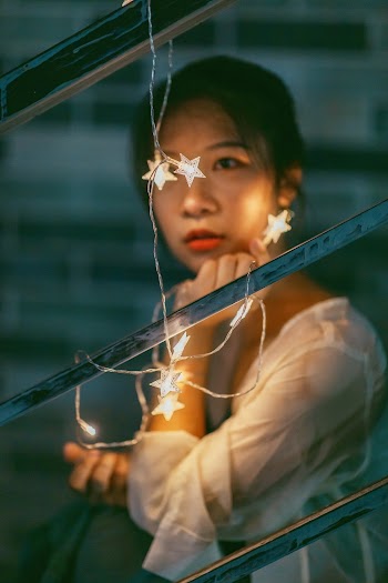Girl Holding String Lights