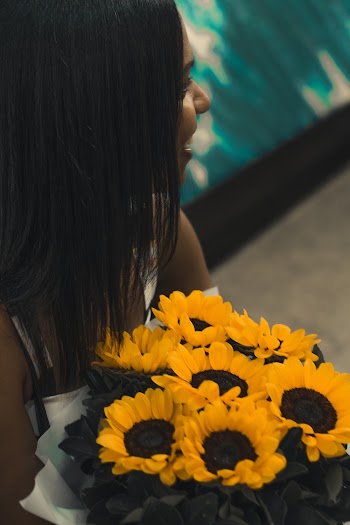 Girl Holding Sunflowers