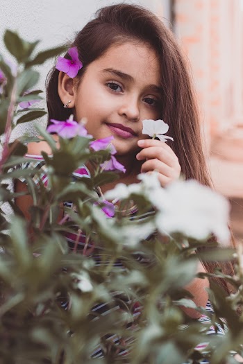 Girl Holding White Petaled Flower