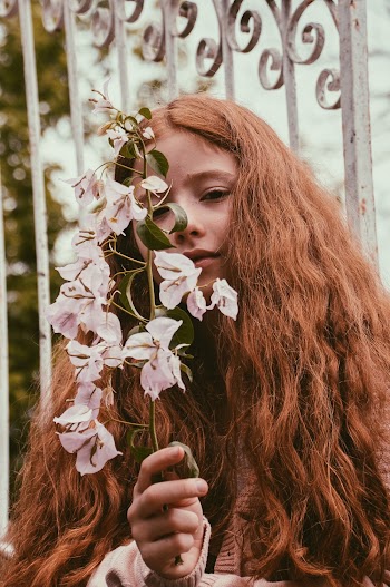 Girl Holding White-petaled Flowers