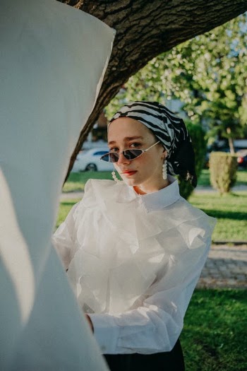 Girl in Blouse and Sunglasses next to Tree · Free Stock Photo