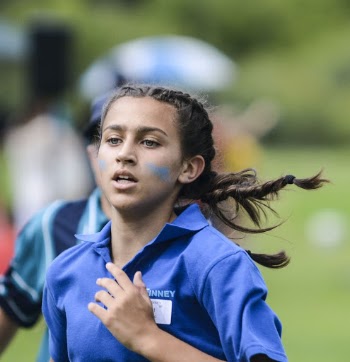 Girl in Blue Polo Shirt Running