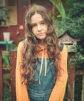 Girl In Orange Shirt And Denim Jumper