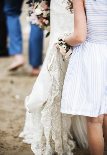 Girl in White and Blue Dress Holding Wedding Dress of Woman