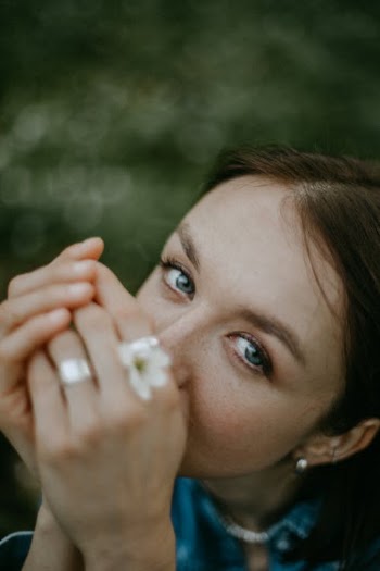 Girl in White Shirt Holding White Flower · Free Stock Photo