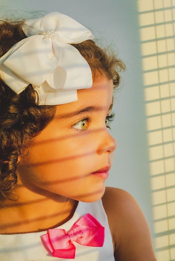 Girl In White Sleeveless Top With A Ribbon