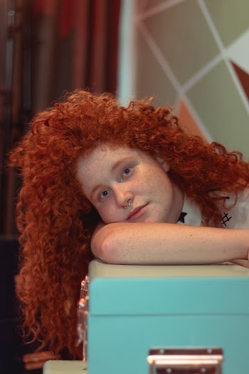 Girl Leaning On Teal Box