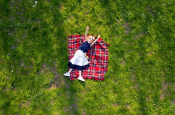 Girl Lying on Flannel Blanket with hands raised