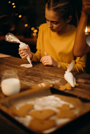 Girl Piping Icing on Heart Cookie