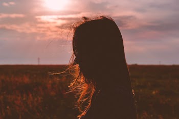 Girl’s head silhouette at sunset