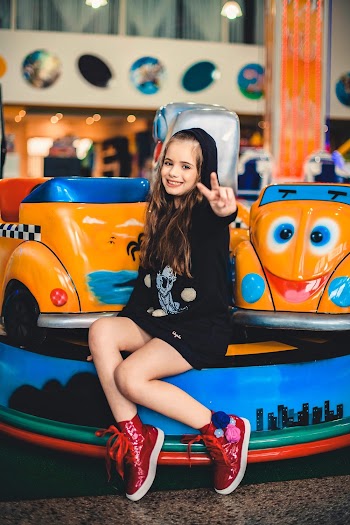 Girl Sitting and Doing Peace Sign