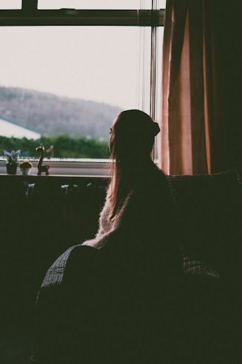 Girl Sitting By The Window