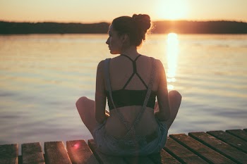 Girl sitting on a pier