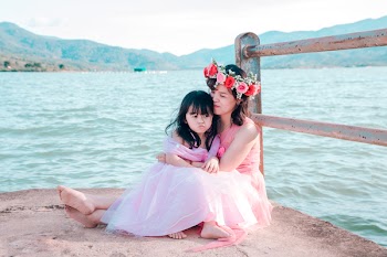 Girl Sitting on a Woman