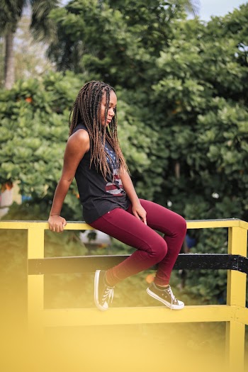 Girl Sitting On A Wooden Handrail