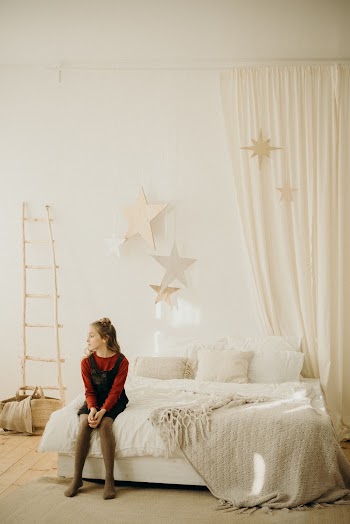 Girl Sitting On Bed