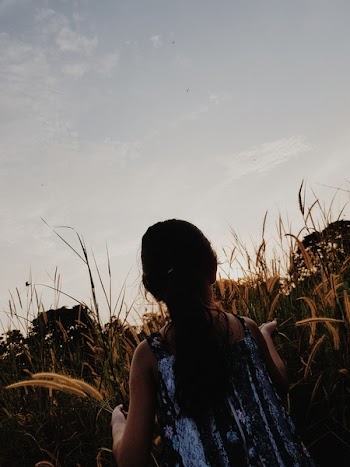 Girl Sitting on Brown Field