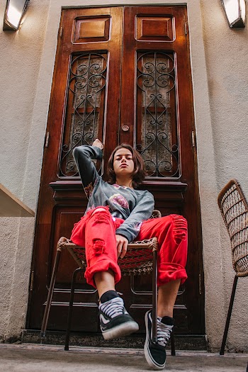 Girl Sitting on Chair Beside The Door