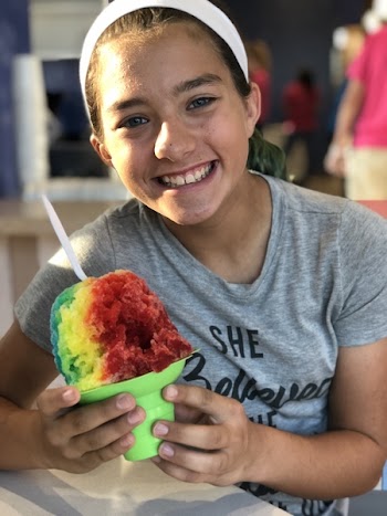 Girl Sitting on Chair While Holding Ice Cream