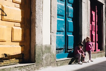Girl Sitting on Concrete Surface