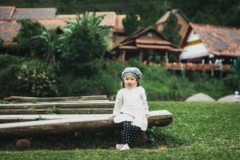 Girl Sitting on Log