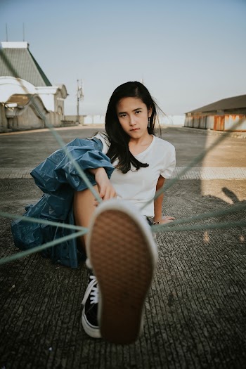 Girl Sitting On The Ground Wearing White Shirt