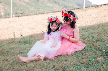 Girl Sitting on Woman Outdoors