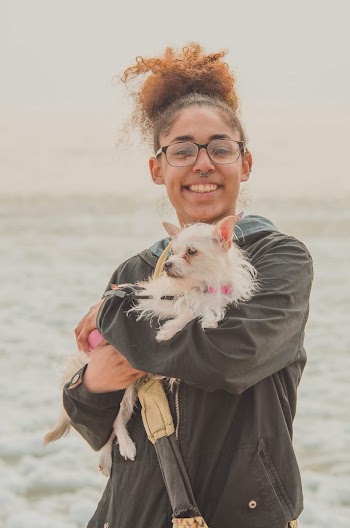 Girl Smiling While Carrying Her Dog