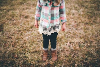 girl standing in brown grass